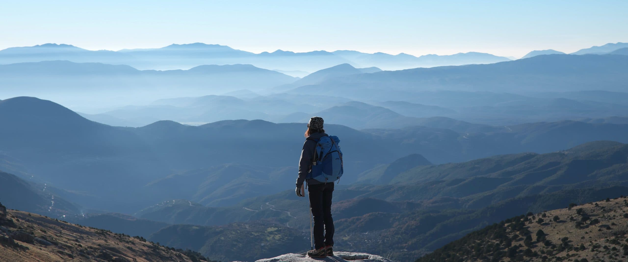Hiker on mountain looking at view